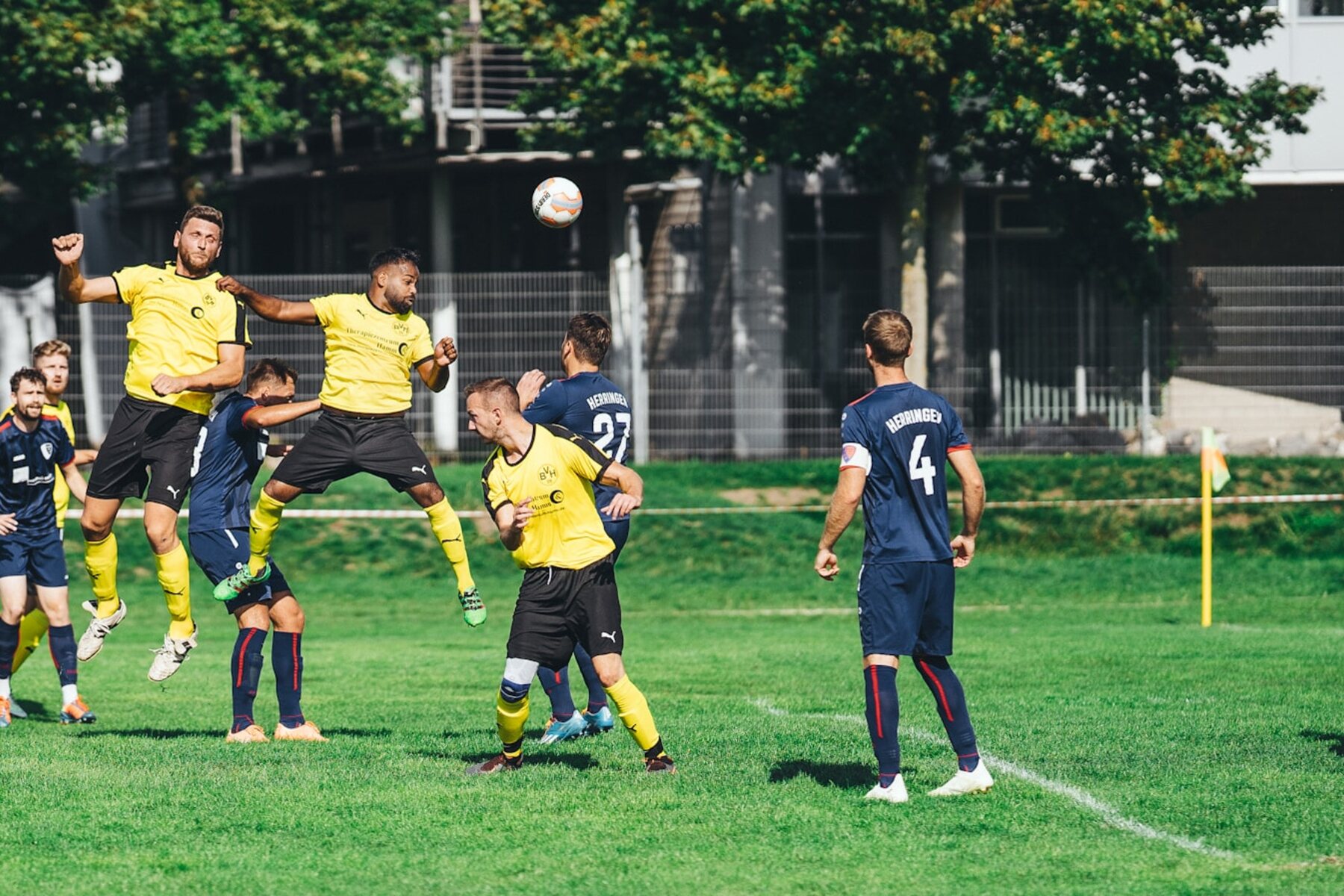 Several football players compete together for the ball